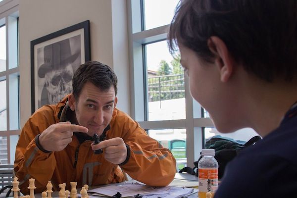 FM Mike Klein playing chess against a younger opponent.