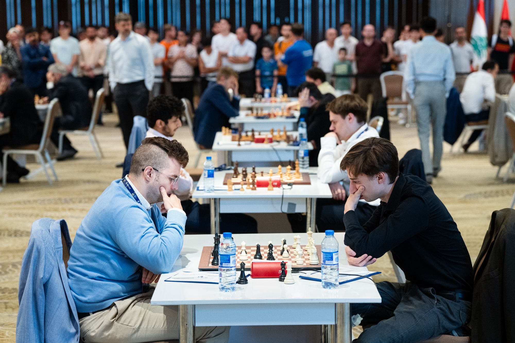 Vocaturo and Dubov in front of other games and spectators
